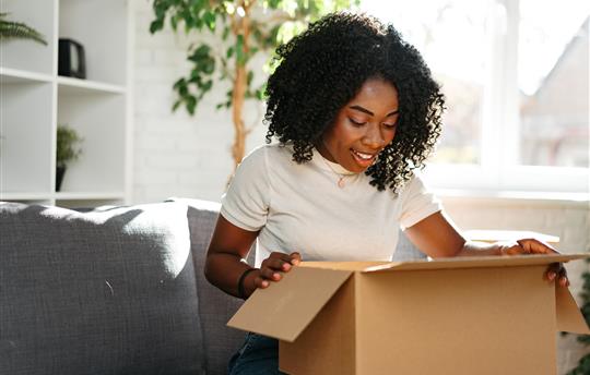 young woman opening a box